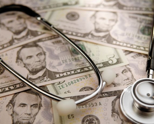 Image of cash and a stethoscope