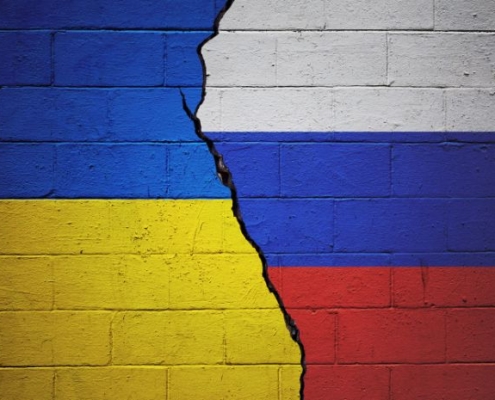 Image of a crack in a wall with Ukrainian colors on one side and Russian colors on the other