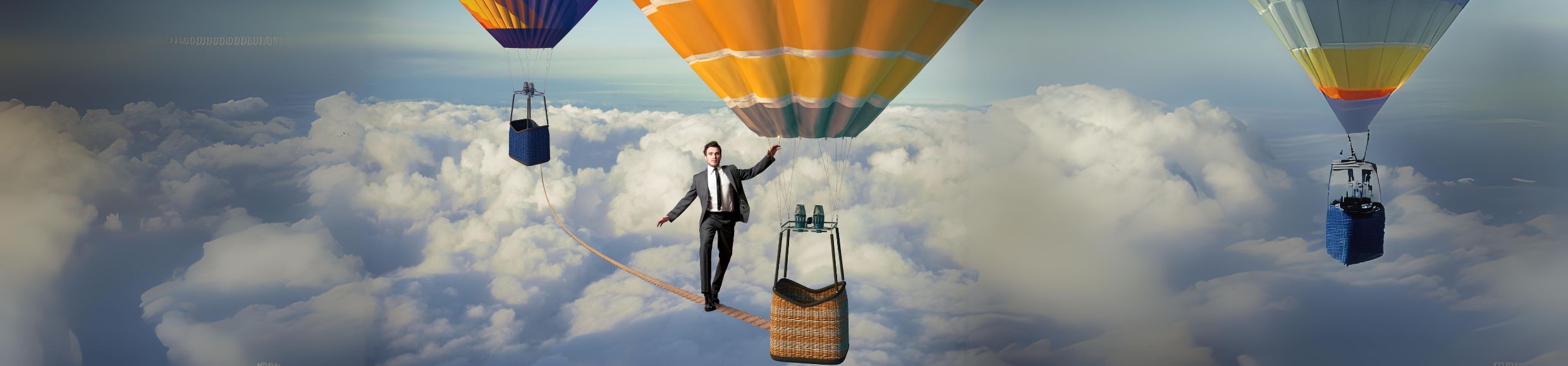 Man walking a tightrope between inflated balloons