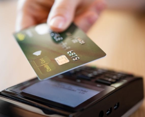 Image of a person using a credit card